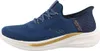 A side view of a blue Skechers slip-on sneaker with gold accents. Voir les images du produit