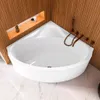 A white corner bathtub with bronze fixtures is shown in a bathroom with wood-paneled walls and marble flooring. Produktbild-Vorschau