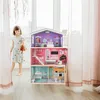A young girl is playing with a dollhouse in a bright room. Náhľad obrázku produktu