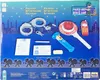 A collection of police-themed toy accessories laid out on a dark blue background with a cityscape silhouette. Podgląd zdjęcia produktu