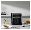 A black air fryer is displayed on a kitchen counter, with food and a drink nearby. Produktbild-Vorschau
