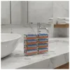 Razor blade refills stacked on a marble countertop next to a sink in a bathroom. Produktbild-Vorschau