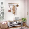 A hallway or entryway with a shoe bench, coat rack, and basket. Voir les images du produit