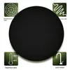 A circular black mat is shown with four green squares in the corners, each containing an icon and text describing its features. Produktbild-Vorschau