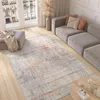 A modern living room with a sofa, rug, ottoman, and coffee table. Anteprima dell’immagine prodotto