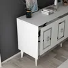 A white sideboard with silver accents and ring handles, placed against a dark gray wall and on a wooden floor. Anteprima dell’immagine prodotto