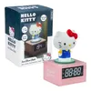 A Hello Kitty alarm clock is shown in its packaging and also displayed separately. Podgląd zdjęcia produktu