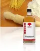 A bottle of wood oil is placed on a white surface, with a wooden rolling pin, spaghetti, and flour in the background. Produktbild-Vorschau