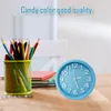 A blue analog alarm clock sits on a wooden desk next to a metal cup filled with colored pencils and some books. Produktbild-Vorschau