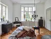 A bedroom scene with a bed, dresser, and vanity. Produktbild-Vorschau