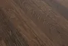 A close-up view of dark brown wooden planks with a visible grain pattern. Produktbild-Vorschau