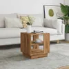 A wooden side table with a cup of coffee and a magazine on it, placed in a living room setting next to a sofa. Produktbild-Vorschau