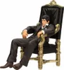 A figurine of Tony Montana from Scarface sitting in a throne-like chair. Náhľad obrázku produktu
