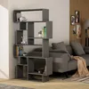 A modern grey bookshelf filled with books and decorative items, placed next to a grey sofa in a living room. Produktbild-Vorschau