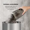 A hand is emptying the dustbin of a vacuum cleaner into a trash can. Produktbild-Vorschau