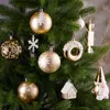 A close-up shot of various Christmas ornaments hanging on a Christmas tree. Náhľad obrázku produktu