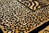 A close-up view of a rug with animal print patterns. Produktbild-Vorschau