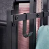Close-up of a black metal towel rack with towels hanging on it. Náhľad obrázku produktu