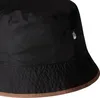 A close-up view of a black bucket hat with a brown trim. Produktbild-Vorschau