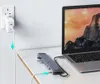A laptop, docking station, and power adapter are set up on a desk, with the power adapter plugged into a wall socket. Produktbild-Vorschau