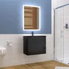 A modern bathroom with a wall-mounted black vanity, a backlit mirror, a toilet, and a glass shower enclosure. Produktbild-Vorschau