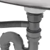 A close-up view of a kitchen sink drain assembly, showing the flexible hose and plumbing pipes. Podgląd zdjęcia produktu