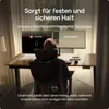 A person is sitting at a desk with two monitors, one showing a 'DESKTRONIC' logo and the other showing 'ANDERE' with a red 'X'. Produktbild-Vorschau