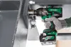A person wearing gloves is using a HiKOKI cordless impact wrench to tighten a bolt on a large metal structure. Voir les images du produit