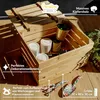 A wooden crate filled with paint cans and gardening tools, placed on a wooden floor with plants in the background. Náhľad obrázku produktu