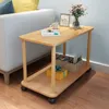A wooden side table with items on it, next to a sofa. Produktbild-Vorschau