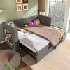 A modern living space with a grey sectional sofa that converts into a bed, featuring integrated charging ports and shelving. The room has large windows overlooking greenery. Anteprima dell’immagine prodotto