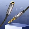 A close-up shot of a Ugreen audio cable with 3.5mm connectors, presented against a gradient blue background with musical notes. Produktbild-Vorschau