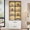 A tall, narrow display cabinet with glass doors and built-in LED lighting, showcasing various decorative items and collectibles. The cabinet has two drawers at the bottom and is placed in a well-lit room with a window and a floor lamp. Anteprima dell’immagine prodotto