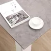 A book and a cup of coffee are placed on a gray table. Produktbild-Vorschau