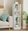 A white bookshelf filled with books and decorative items in a living room setting, next to a sofa. Produktbild-Vorschau