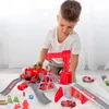 A young boy is playing with a toy fire station playset. Produktbild-Vorschau