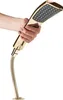 A hand holding a gold shower head with a flexible hose attached. Produktbild-Vorschau