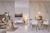A modern living room and bedroom area with marble walls and white wooden floors. Anteprima dell’immagine prodotto