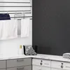 A laundry room with a drying rack, washing machines, and a countertop. Produktbild-Vorschau