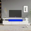 A modern living room setup featuring a white TV stand with blue LED lighting and a large television. Produktbild-Vorschau