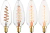 Four clear glass LED candle bulbs with gold bases are arranged in a row against a white background. Each bulb contains a spiraled filament that glows with varying degrees of warmth. Produktbild-Vorschau