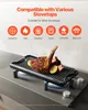 A cast iron grill pan with a steak and lemon slices on a stovetop. Anteprima dell’immagine prodotto