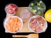 A collection of food items, including meat, vegetables, and fruit, are prepared and covered with plastic wrap on a wooden board. Náhled obrázku produktu