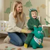 A mother and child playing with a green inflatable dinosaur toy in a nursery. Podgląd zdjęcia produktu