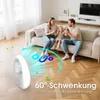 A family is relaxing on a couch while a white fan circulates air. Náhled obrázku produktu