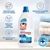 A bottle of Omino Bianco laundry additive is shown with various feature callouts and a stack of folded laundry in the background. Produktbild-Vorschau