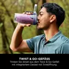 A man drinking from a portable blender outdoors. Náhled obrázku produktu