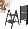 A woman is using a step stool to hang clothes on a drying rack in a laundry room. A separate image shows the step stool folded. Voir les images du produit