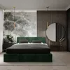 A bedroom with a green upholstered bed, a large mural on the wall, and a round mirror. Náhled obrázku produktu