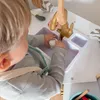 A child playing with a toy kitchen sink. Podgląd zdjęcia produktu